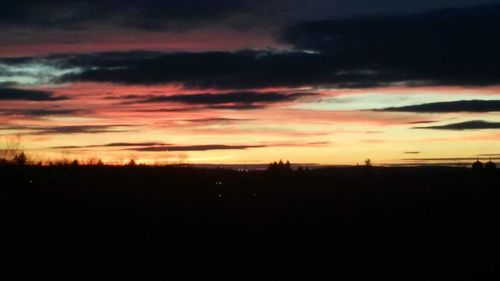 Silhouette landscape against sky during sunset