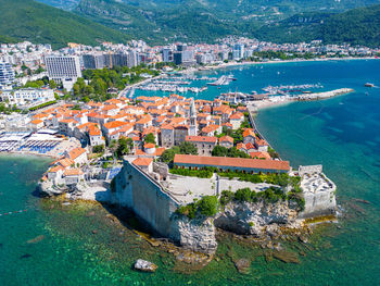 High angle view of townscape by sea