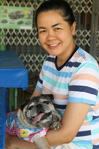 Portrait of smiling woman with dog