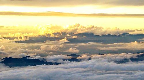 Scenic view of mountain range against cloudy sky