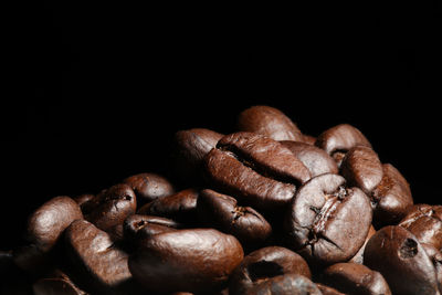 Close-up of coffee beans against black background