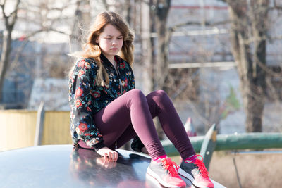Young woman sitting outdoors