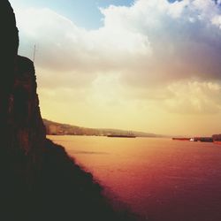 Scenic view of sea against cloudy sky