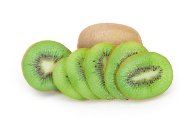 Close-up of green fruit against white background