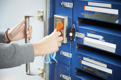 Cropped image of student unlocking door with cardkey at university