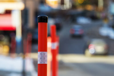 Close-up of red pole on street in city