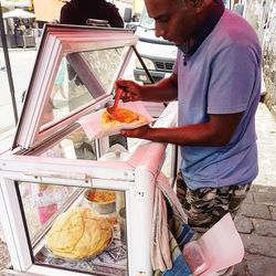 Man working on ice cream at market