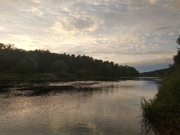 Scenic view of lake against sky at sunset