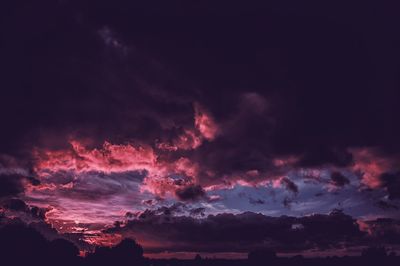 Low angle view of lightning against sky during sunset