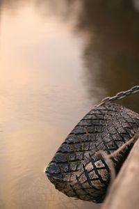 High angle view of tire hanging over lake