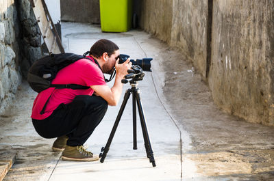 Rear view of woman photographing