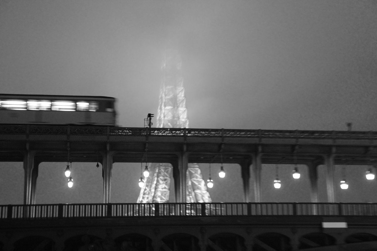 LOW ANGLE VIEW OF BRIDGE AT NIGHT