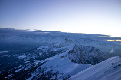 Scenic view of snowcapped mountains against clear sky