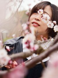 Portrait of woman with pink flowers