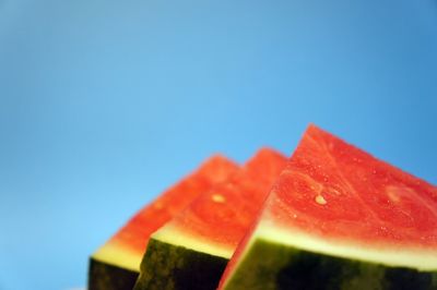 Close-up of watermelon slices against blue background