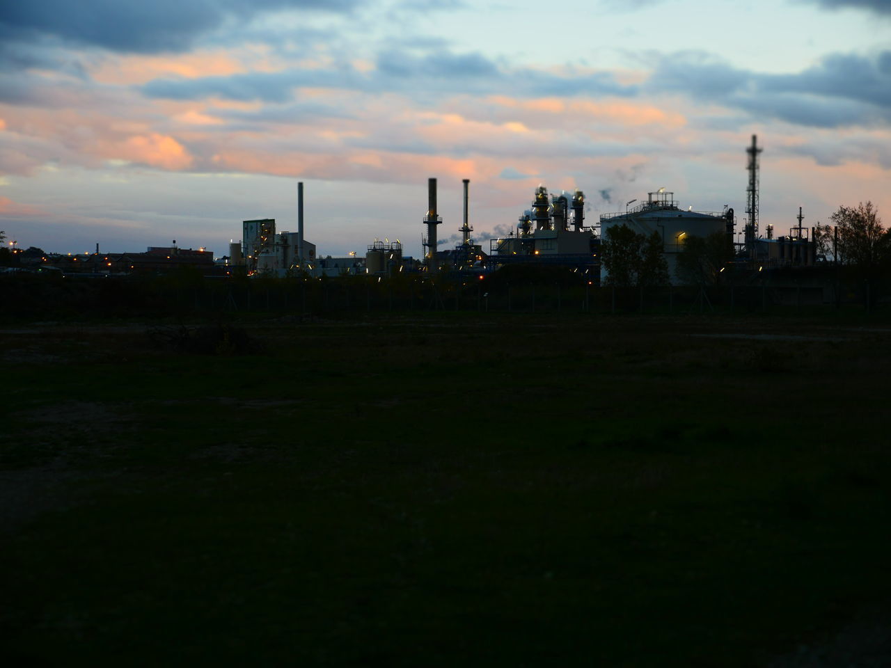 SILHOUETTE OF FACTORY AGAINST SKY