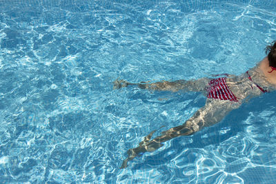 High angle view of woman swimming in pool