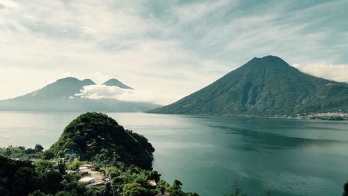 Scenic view of lake against cloudy sky