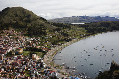 High angle view of townscape by mountain against sky