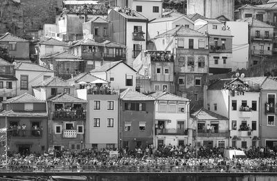 Crowd on street and buildings in residential district during traditional festival