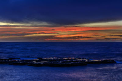 Scenic view of sea against sky at sunset