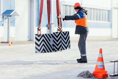 Side view of man working at construction site