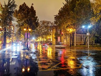 Wet illuminated city street during rainy season