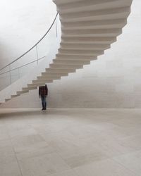 Rear view of people walking on staircase