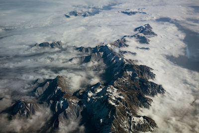 Aerial view of snowcapped mountains against sky