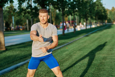 Portrait of young man exercising in park