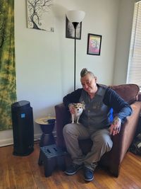 Man sitting on sofa at home