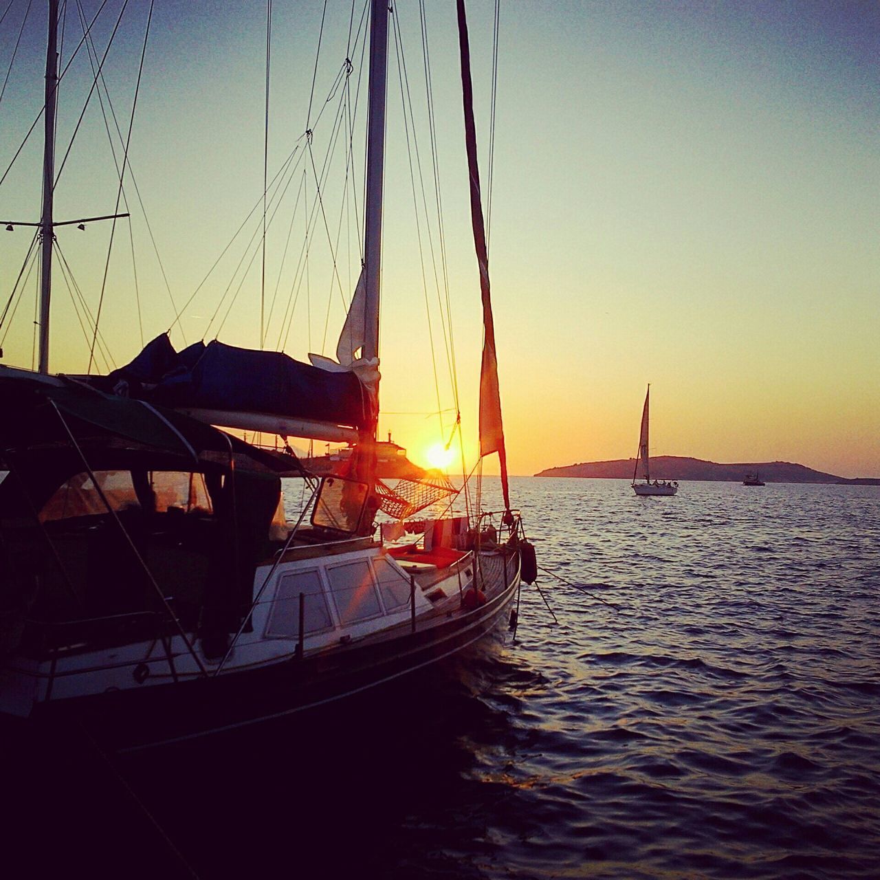 sunset, water, transportation, sea, waterfront, built structure, nautical vessel, orange color, architecture, sky, rippled, boat, sun, river, nature, silhouette, tranquility, sunlight, mode of transport, connection