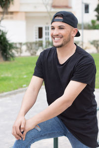 Young man stretching on footpath