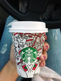 Close-up of hand holding coffee cup