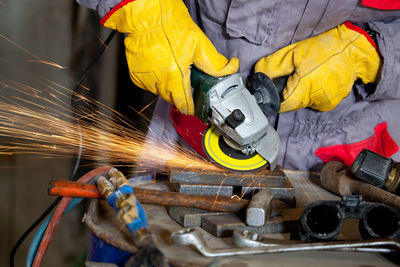 Midsection of worker working in workshop