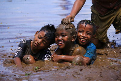 Cute kids playing in mud