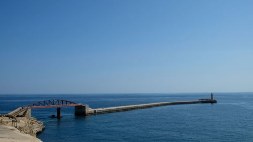 Scenic view of sea against clear blue sky