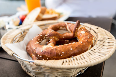 Close-up of pretzels in wicker basket on table