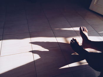 Low section of woman on tiled floor