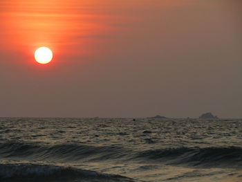 Scenic view of sea against orange sky