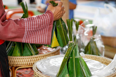 Midsection of woman holding food at market