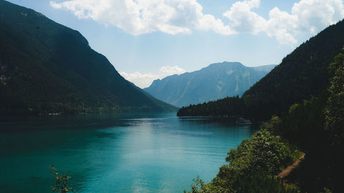 Scenic view of lake and mountains against sky