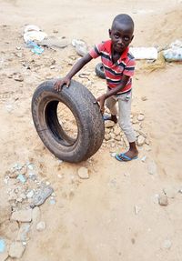 Full length of boy standing on mud