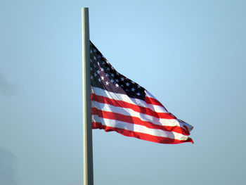 Low angle view of american flag against clear sky