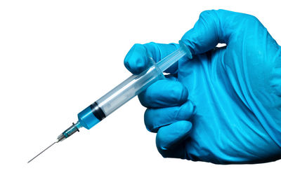 Midsection of person holding umbrella against white background