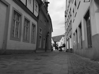 Empty alley amidst buildings in town