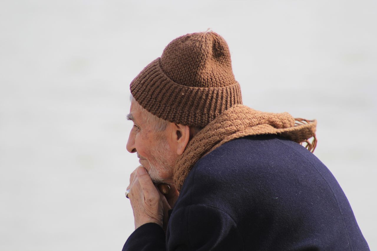 CLOSE-UP OF MAN WITH SNOW ON BACKGROUND