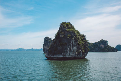 Scenic view of rock formation in sea against sky