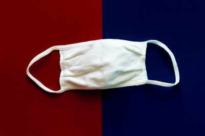 Rear view of two flag against blue background