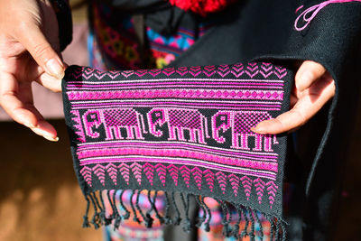 Midsection of woman holding embroidery fabric